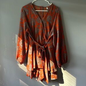 Orange and blue romper with cleavage button and long back zipper to get in easy